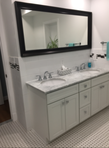 white double sink vanity with large mirror dark border